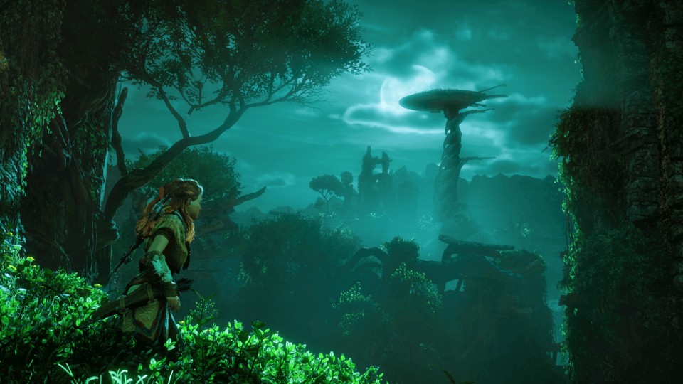 Aloy, the protagonist of Horizon: Zero Dawn, wearing red braided hair, animal skin clothing, a bow, and a quiver, stands in a moonlit jungle and looks at a giant giraffe-like robot in the distance.