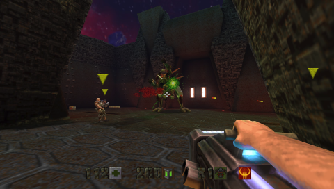 First-person view of a character firing a BFG10K at the final boss, Makron, who controls an exoskeleton that resembles a goat-like demon. There are on-screen indicators of at least three other players, one of whom is a human male soldier, another is a cyborg, and the third is obscured by a pillar.