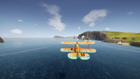 Yellow and white biplane flying over calm sea. On the right is a land mass with cliffs, an arch over the water, green fields and a small sailboat near a sandy beach.