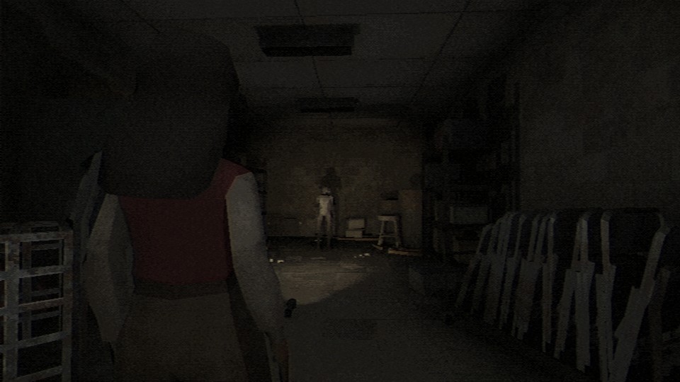 A woman with long dark hair, wearing a white shirt, sweater vest and khakis, stands with her back to the camera in a dilapidated school hall. There is a flashlight on the ground shining on a humanoid figure in the distance. The overall style is inspired by PlaysStation One, with low-poly models, simple textures and a lot of noise.