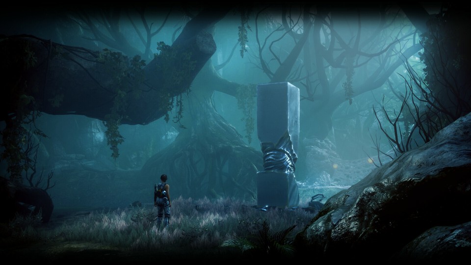 Small figure of an olive-skinned woman with dark hair in a ponytail standing in a forest. She is wearing gray jumpsuit bottoms, a dark tanktop, a harness, and a backpack with a blocky looking weapon attached to it. Forest, lit by a dim, cold light, full of twisted trees and less earth-like stuff on a perimeter. In the middle of it is a square stone column with the central part chiselled out in a shape that makes it look somewhat organic.