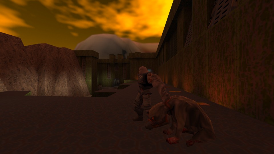 The place looks like a medieval castle courtyard, but with rust-coloured walls and metal grates. There is a natural stone wall on one side and mountains in the background. Above it all are acid skies of yellow and green. There stands an Enforcer, a burly, bold Strogg who is holding a dog-like creature with a flat face and meat-coloured skin (or lack thereof) by its neck.