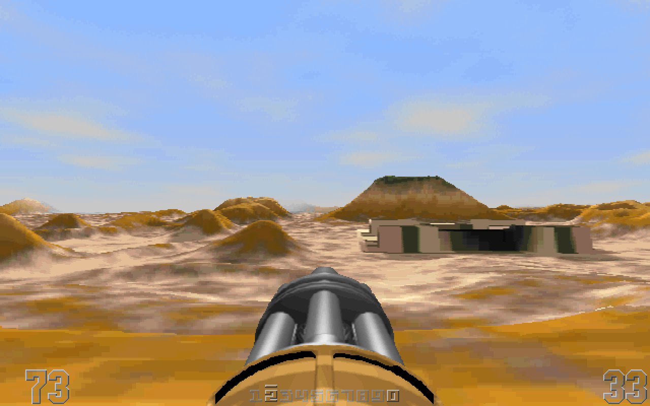 The mesa-colored alien landscape, from white-ish yellow to black-ish brown. There are hills and a truncated-pyramid mountain in the distance. There is also a low cement structure of some sort. In the middle of the first-person view is a huge six-barreled machine gun.